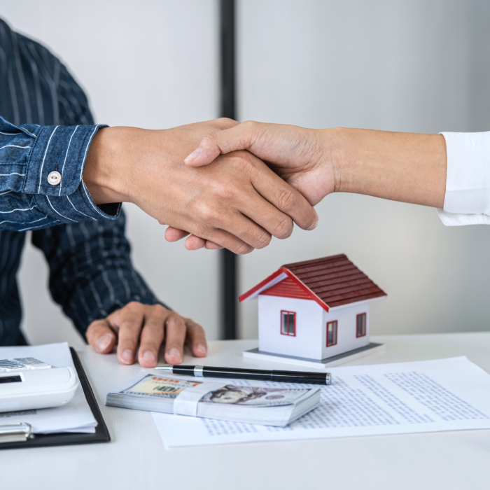 Real estate agent and customers shaking hands together celebrati