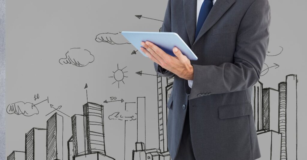 A picture of man in suit (cropped below the neck) using a tablet with a background of city scape drawing art.